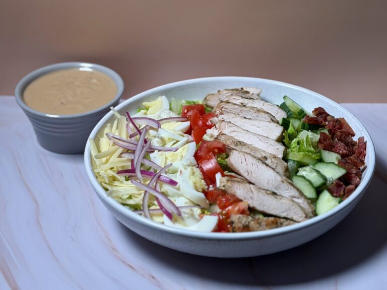 Easy Cobb salad with grilled chicken, eggs, bacon, cheddar, fresh vegetables, and creamy balsamic dressing