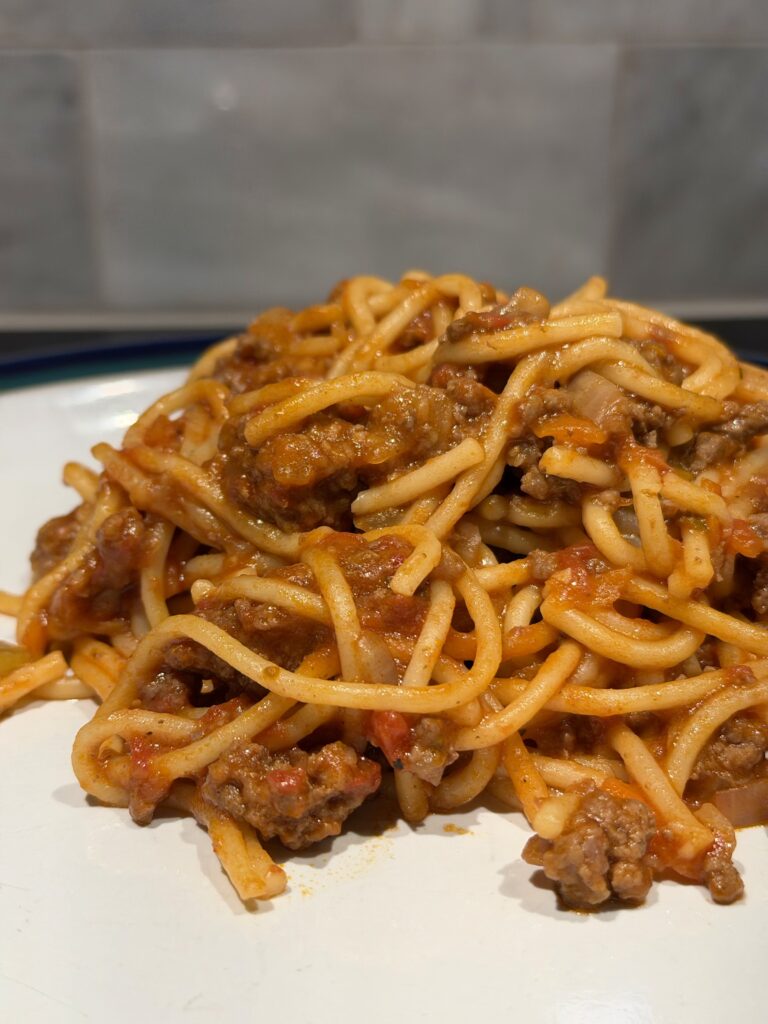 close up of cooked instant pot spaghetti with been and marinara on a plate